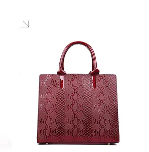 Rear view of the dark red glossy patent leather handbag with snakeskin embossed texture