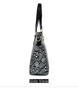 Side view of faux leather tote bag featuring grey snakeskin texture and gold hardware