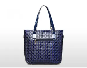 Detail of dark blue geometric embossed tote bag showing back zipper pocket and texture