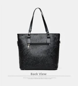 Close-up of black lychee texture tote bag back view with metallic zipper pocket detail