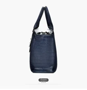 Side view of dark blue crocodile pattern tote bag with polished leather texture