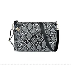 Front view of snake skin pattern handbag with elegant metallic buckle and black strap