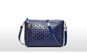 Blue faux leather shoulder bag with embossed star patterns and gold hardware details