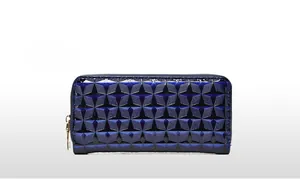Detail view of dark blue glossy patent leather wallet with geometric diamond texture