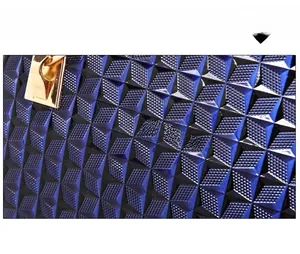 Close-up of dark blue patent leather tote bag with 3D diamond pattern and gold logo