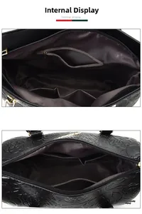 Detail of black leather handbag interior showing zipper pocket and dual storage slots
