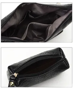 Detail view of black embossed rose leather tote bag and wallet with spacious interior lining