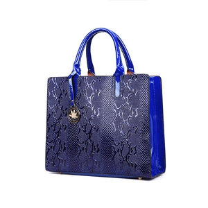 Navy blue snake skin textured kelly handbag with glossy finish and gold maple leaf charm