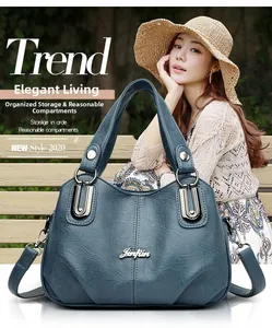Detail view of large blue faux leather tote bag showing organized interior compartments