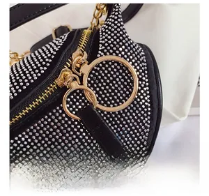 Close-up of sparkling silver rhinestones and premium gold metal zipper details on bag