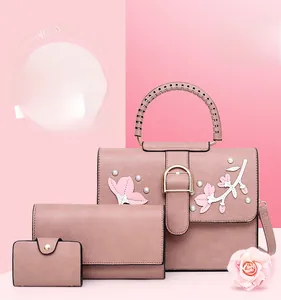 Detailed set of pink handbags with 3D floral embroidery, pearls and woven handles