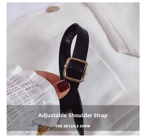 Close-up of adjustable black leather shoulder strap with a polished gold buckle