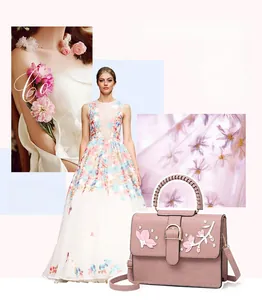 Detail of pink faux leather bag with 3D floral petals, white embroidery and pearl accents