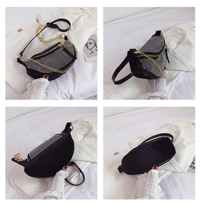 Detail of black crescent crossbody bag featuring silver rhinestones and gold chain