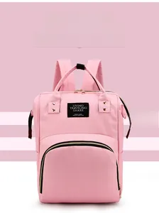 Front view of pink multipurpose mommy backpack with large zipper pocket and waterproof fabric