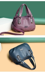 Detail of soft vintage leather texture and silver metal logo on purple and blue handbags