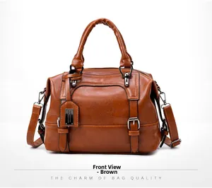 Front view of a vintage brown leather Boston bag with dual handles and metal logo detail