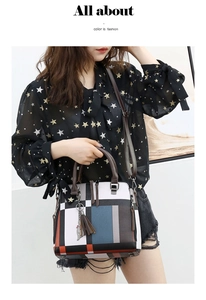 Fashionable color block tote bag with geometric panels and decorative tassel on a model