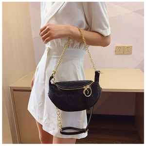Close-up of black rhinestone moon bag with gold chain strap and large ring zipper detail