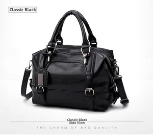 Side view of elegant black leather Boston handbag showing texture and metallic buckle