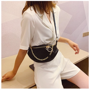 Detail of black rhinestone crescent crossbody bag with thick gold chain and round zipper