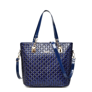Navy blue patent leather tote bag featuring geometric quilted texture and gold hardware
