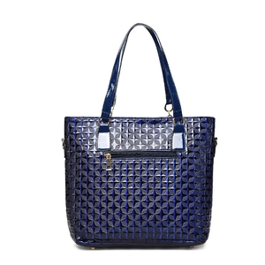 Glossy navy blue geometric quilted tote bag with golden hardware on white background