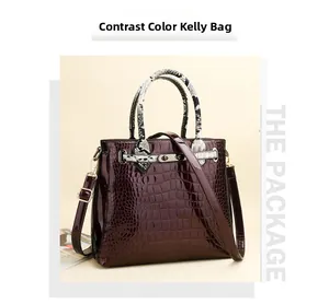 Detail of burgundy crocodile-embossed leather handbag with contrast snake-print handles