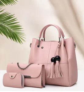Detailed set of three pink faux leather bags including tassel tote and chain purse