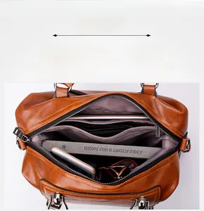 Interior view of the brown leather handbag showing spacious multi-layer compartments