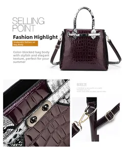 Detail of purple faux crocodile texture bag with snake pattern handle and golden lock