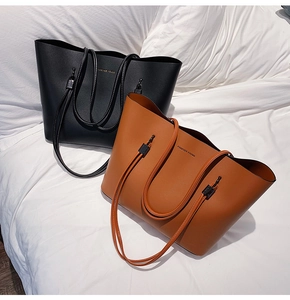 Close-up of Forever Young leather tote bags in black and brown on a white background