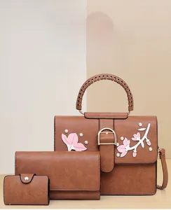 Detailed set of brown tote bag with floral embroidery, matching wallet and card holder
