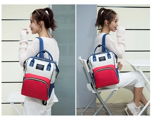 Detail of multi-purpose travel backpack with wide fish-mouth opening and gold zippers