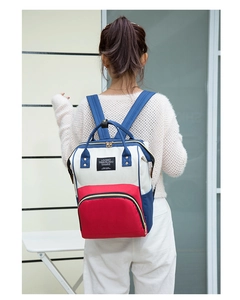 Detail of tricolor waterproof canvas backpack with Living Traveling Share label