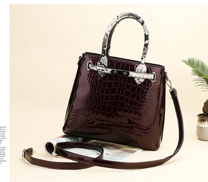Macro detail of wine red faux crocodile leather texture and glossy patent finish