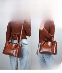 Brown vintage patent leather tote bag shown in both shoulder and handbag carrying styles