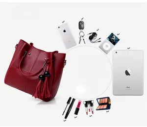 Detail view of a large red tote bag showing storage capacity for iPad and phone