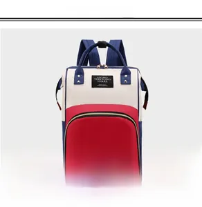 Detailed view of tricolor patchwork backpack with large front pocket and top handles