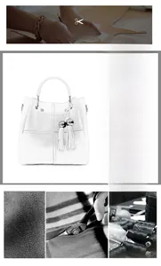 Detail of white lychee leather handbag featuring silver tassel and elegant stitching