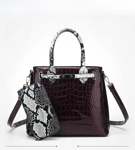 Detail view of purple crocodile texture handbag and snakeskin pattern long wallet set
