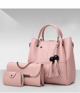 Three-piece pink PU leather handbag set including tote with tassel, crossbody and mini pouch