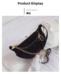 Detail of black crescent moon bag featuring sparkling rhinestones and a gold chunky chain