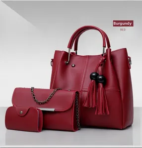 Three-piece wine red tote bag set with fringe detail and textured synthetic leather