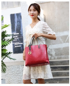 Red crocodile embossed tote bag featuring a snake pattern handle and gold metal F-pendant