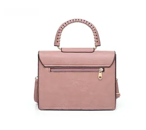 Rear view of dusty rose handbag featuring back zipper pocket and woven top handle details