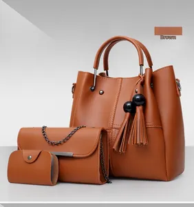 Detailed view of the 3-piece brown faux leather tote bag set with tassel and gold chains