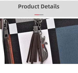 Close-up of checkered bag texture with metallic cat charm and brown leather tassel