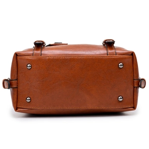 Retro brown oil leather handbag featuring protective metal feet on the bottom base