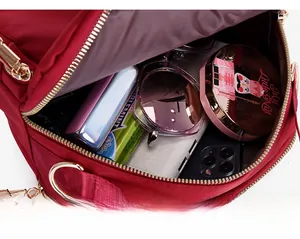 Macro view of red nylon crossbody bag showing spacious interior for daily essentials